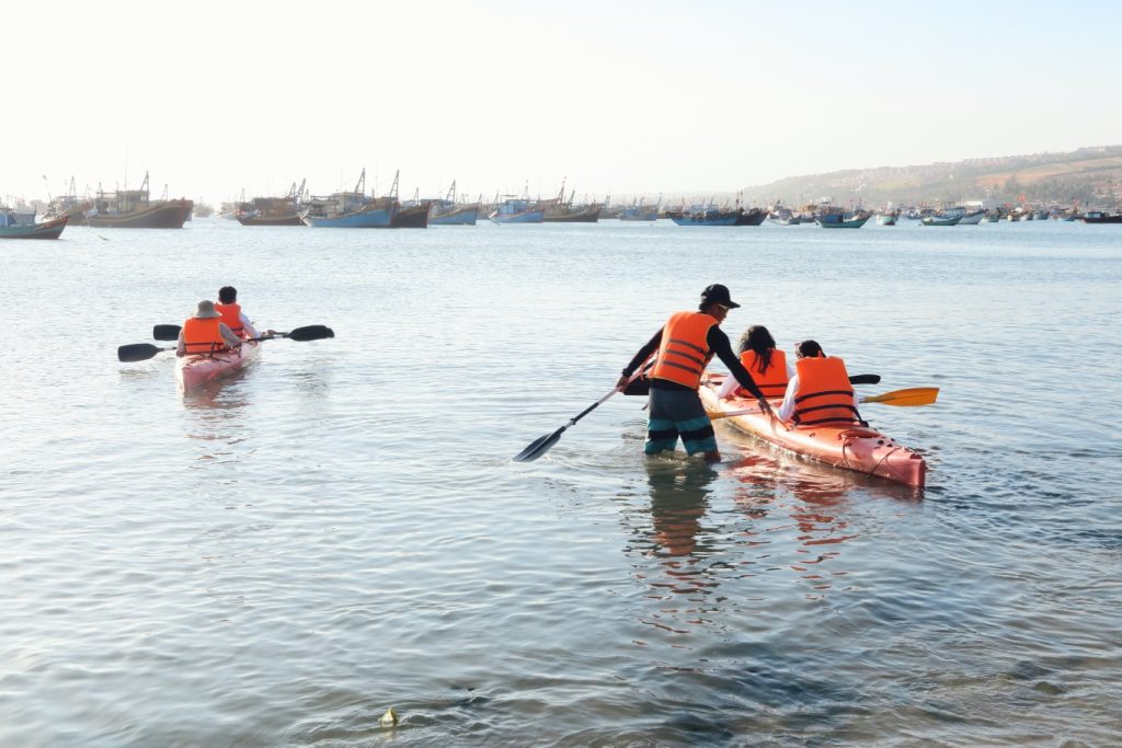 Morning kayaking across Lang Co Bay, passing local fishing villages and floating houses.