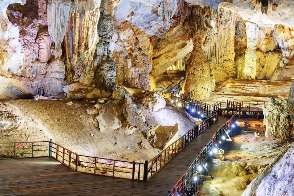 Panoramic view with wooden walkways inside the massive chamber.