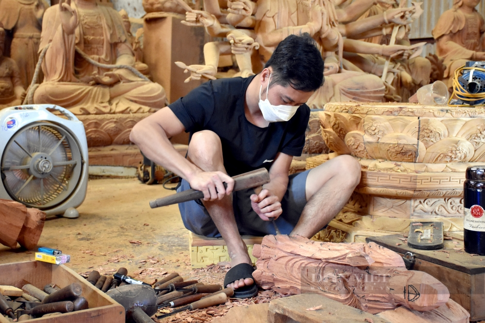 Local craftsman carving wood in Kim Bong carpentry village near Hoi An