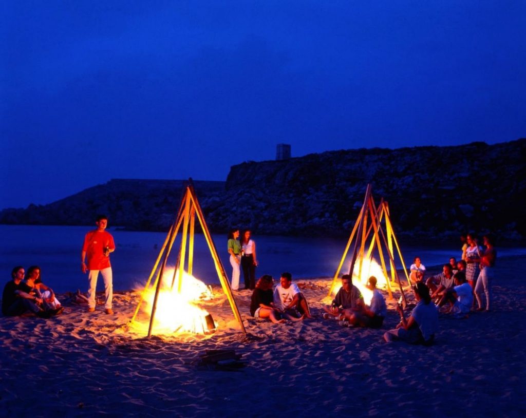 Travelers sitting by a bonfire on An Bang Beach.