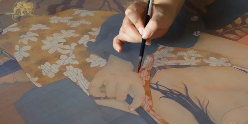 Close-up of a silk frame and watercolor palette.