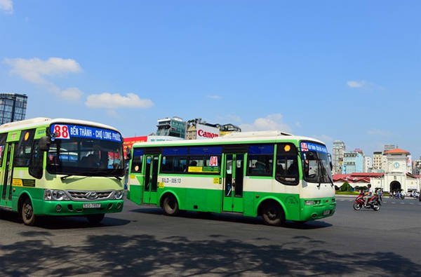 Shuttle bus with tourists heading to Cu Chi