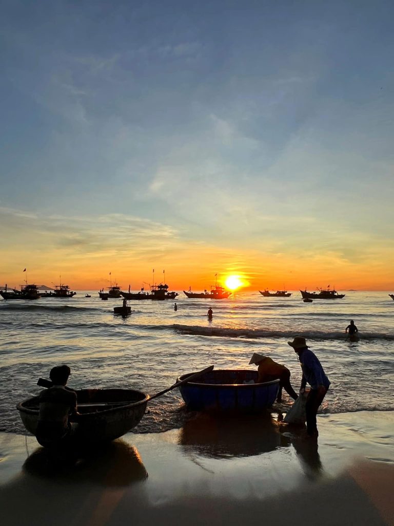 Sunrise over An Bang Beach with basket boats and wooden boats
