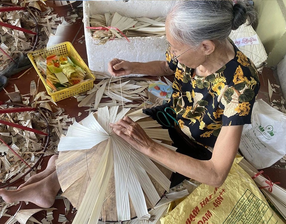 Artisans crafting conical hats