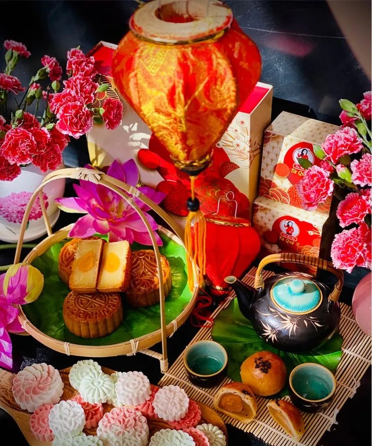 A festive mooncake tray next to Hoi An lanterns.