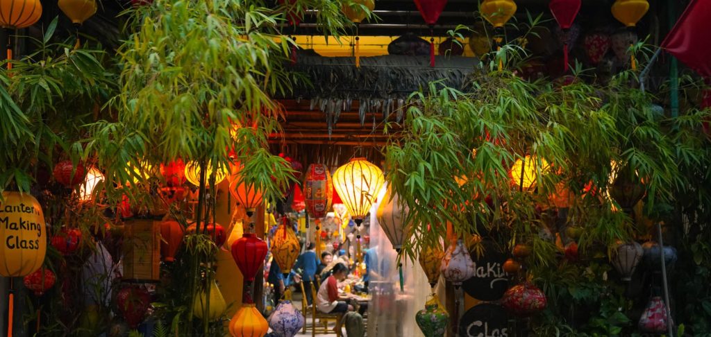 Tea set with lanterns glowing in the background.