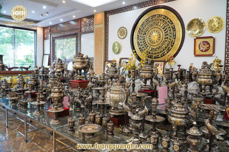 Close-up of bronze bells, incense burners, and statues inside the workshop.