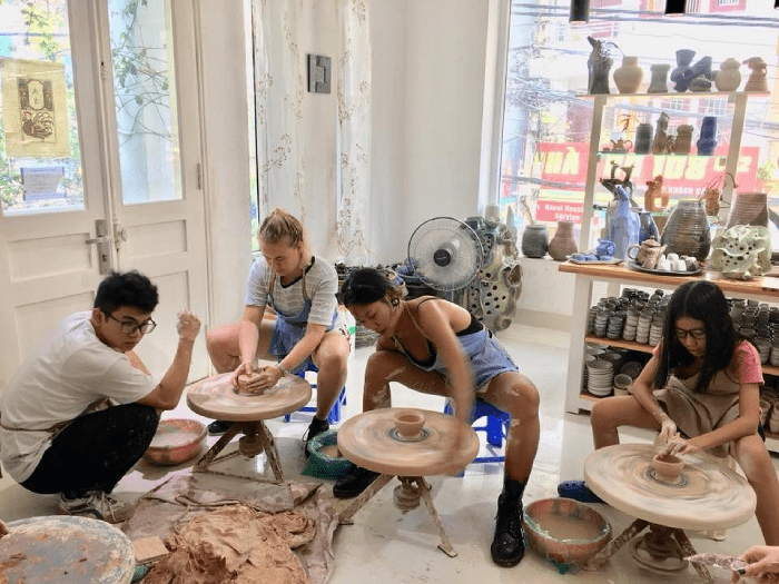 Tourist taking photos of pottery process
