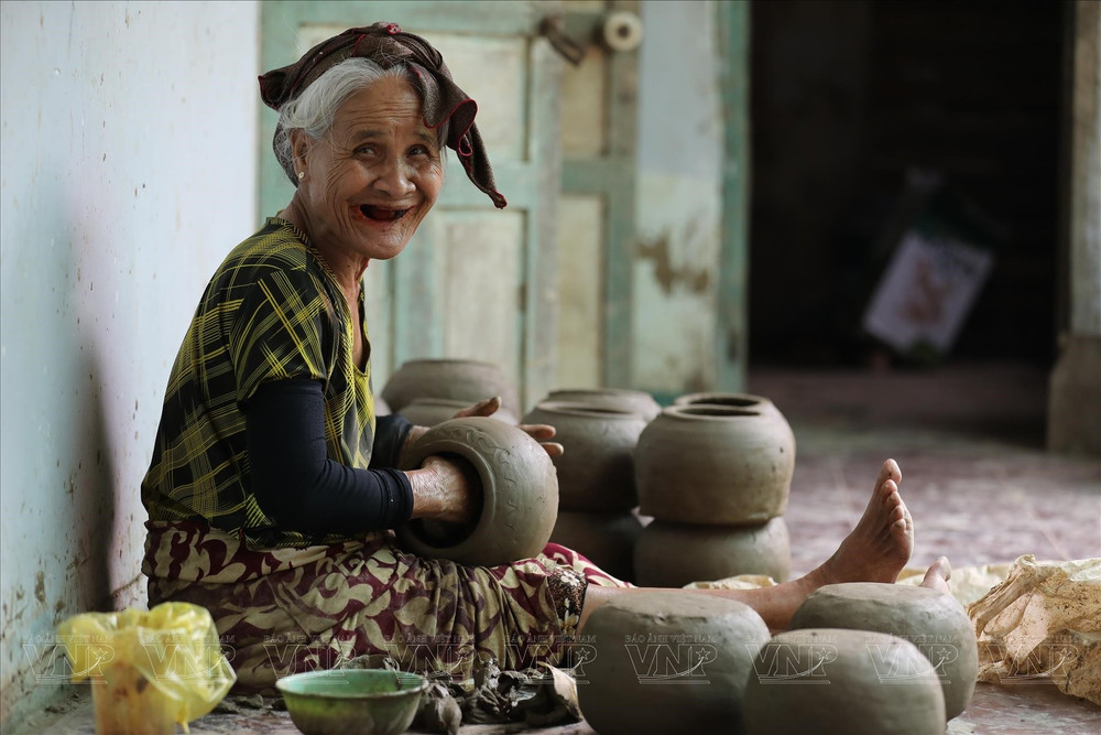 Artisans shaping pottery by hand in Bau Truc